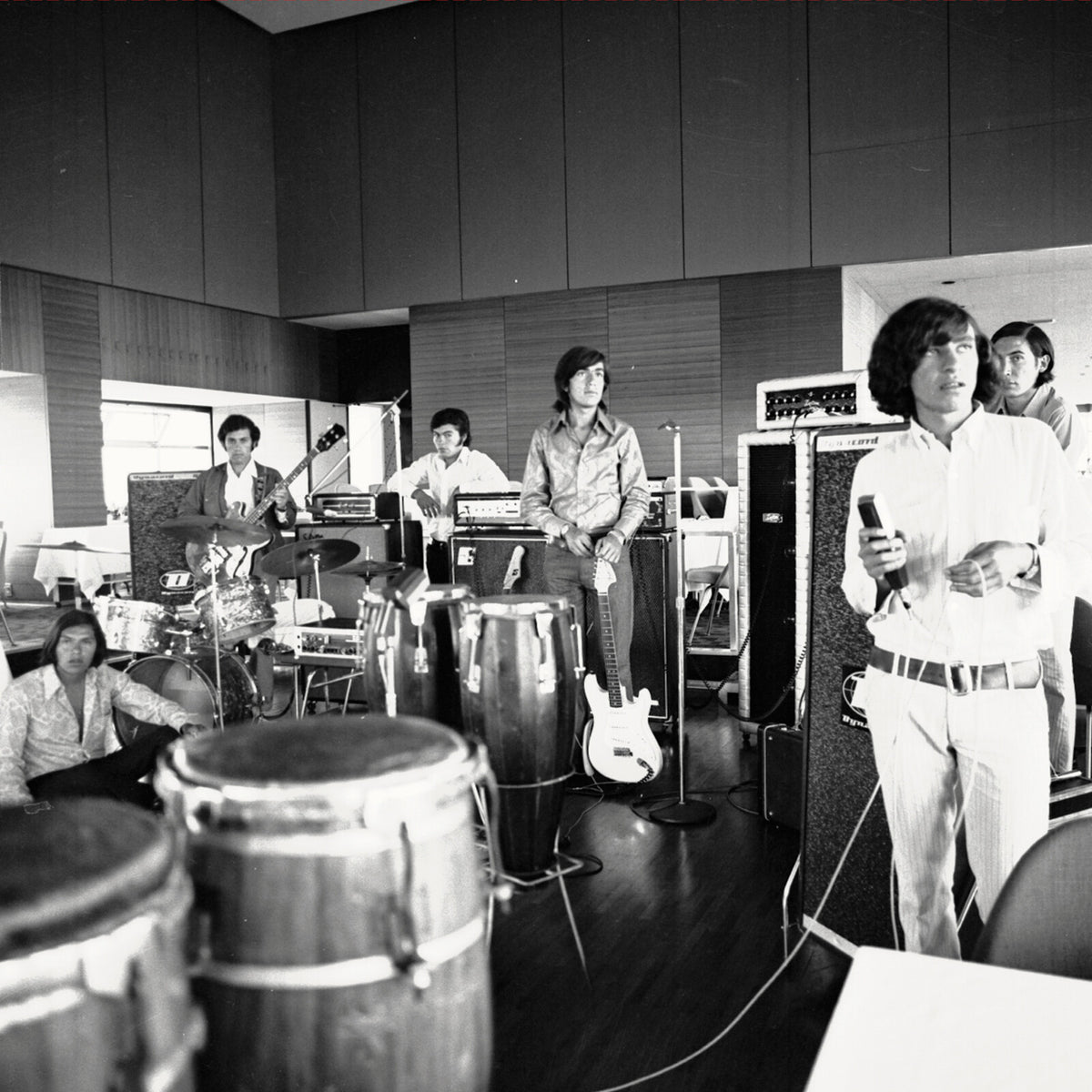 Black and white photo of Los Texao band members in a recording studio.
