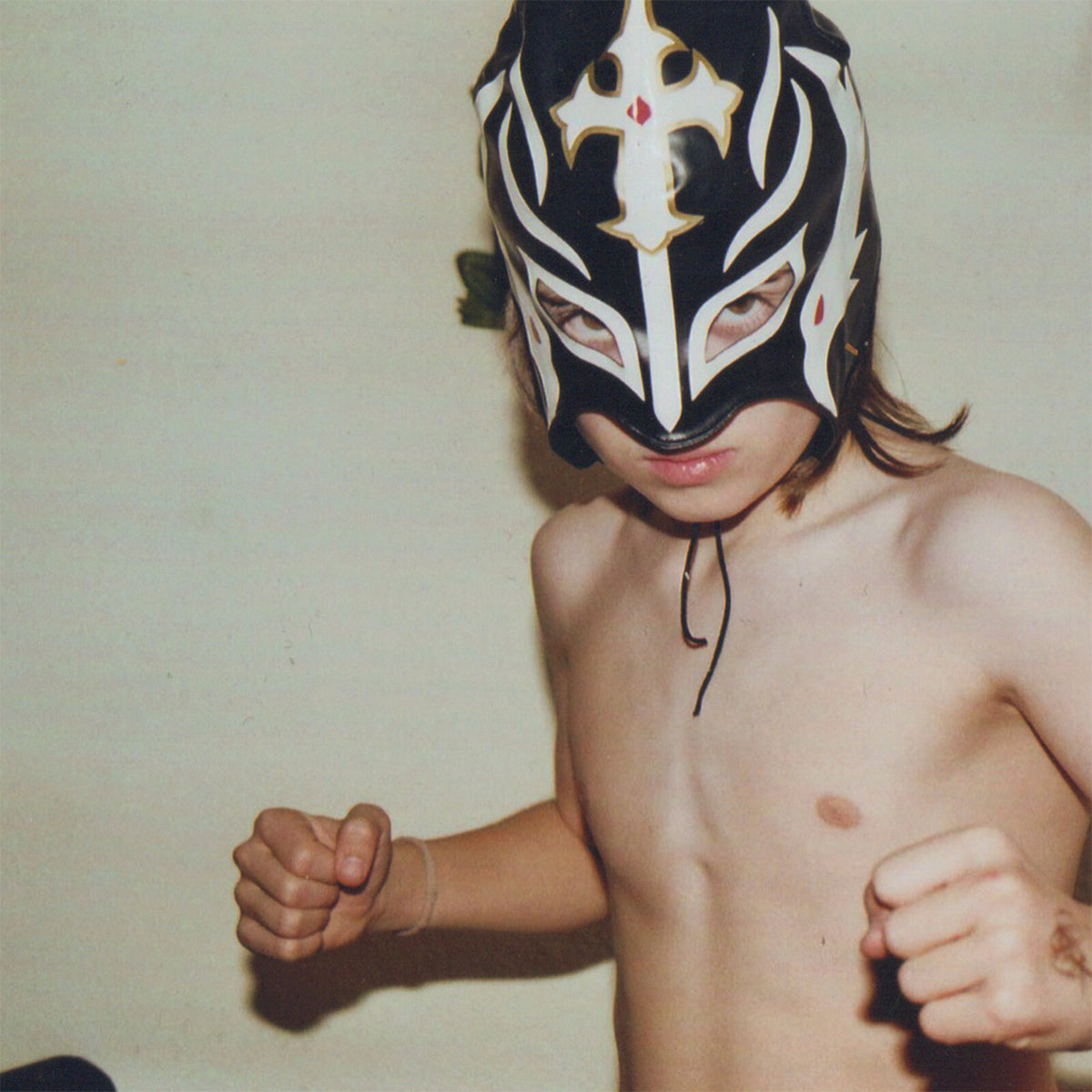Child wearing a black and white lucha libre wrestling mask.