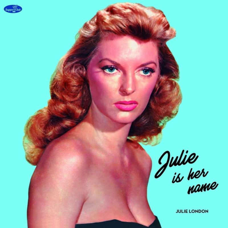 Portrait of Julie London with auburn hair against a bright turquoise background.