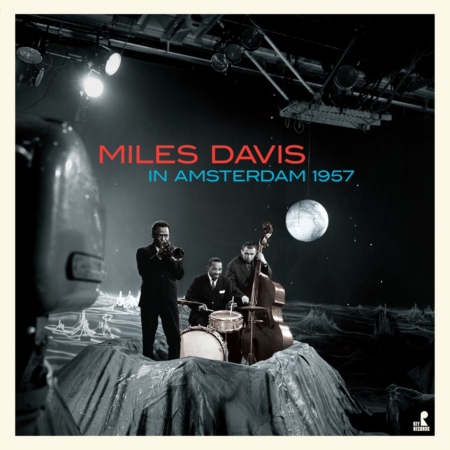 Black and white photo of Miles Davis and his band performing on a stage.