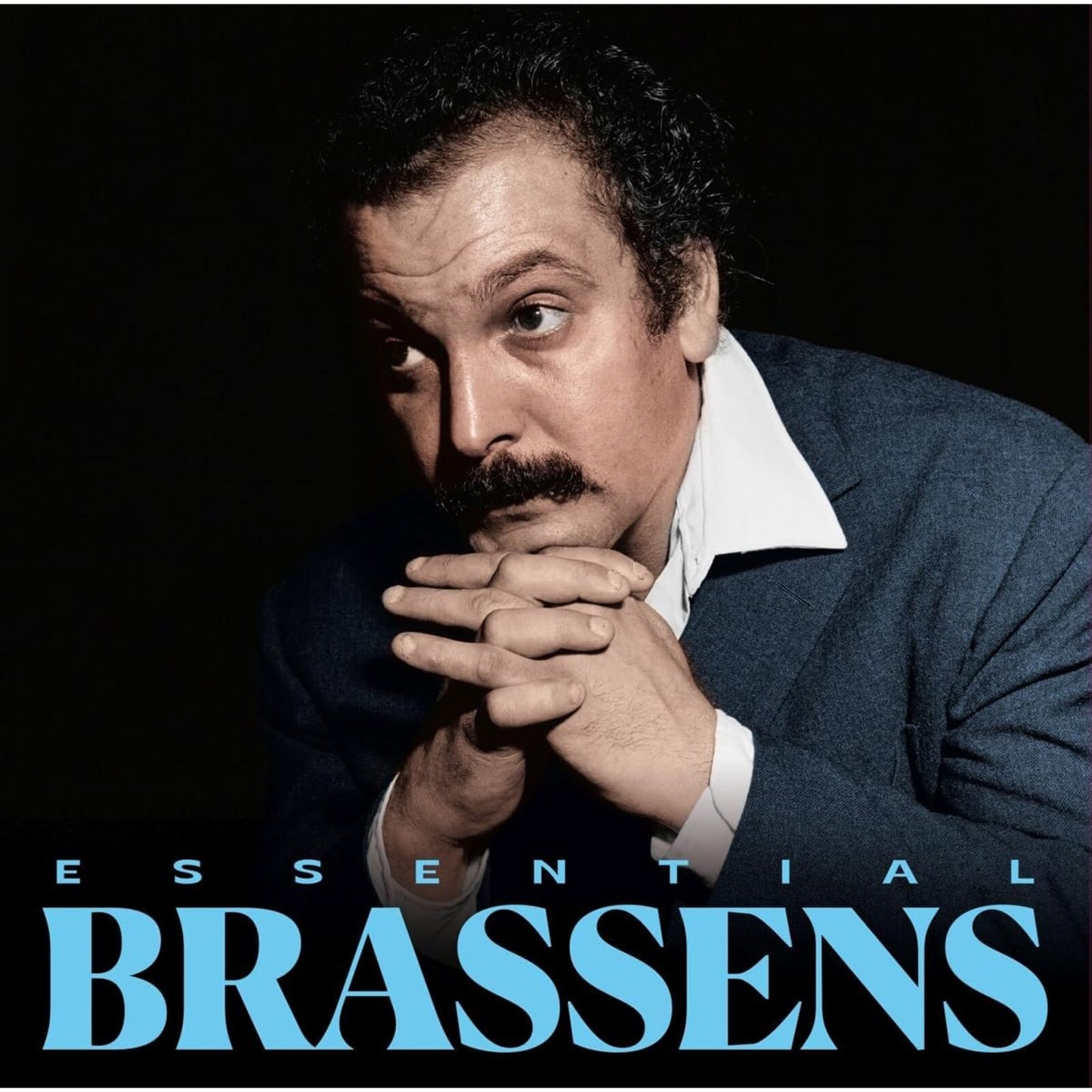 Portrait of Georges Brassens with hands clasped, against a black background.