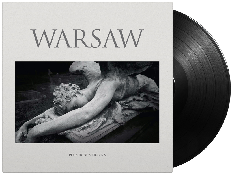 Vinyl record with album cover featuring a statue in grayscale.