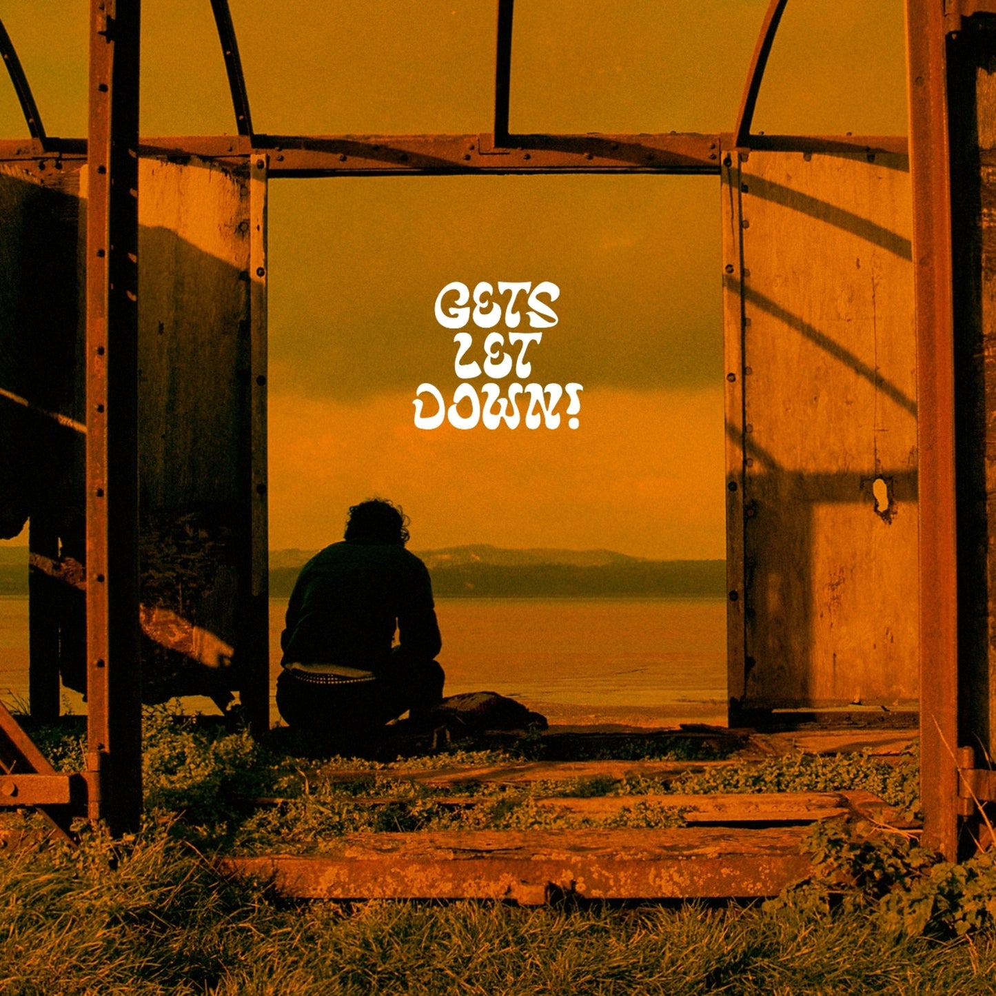 Vinyl record cover: person sits before a doorway and ocean view.