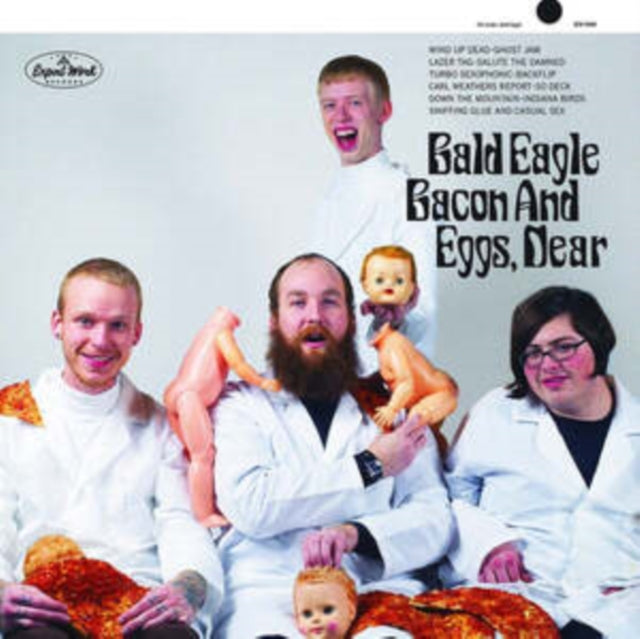 Four men in lab coats pose with bacon, eggs, and baby dolls.