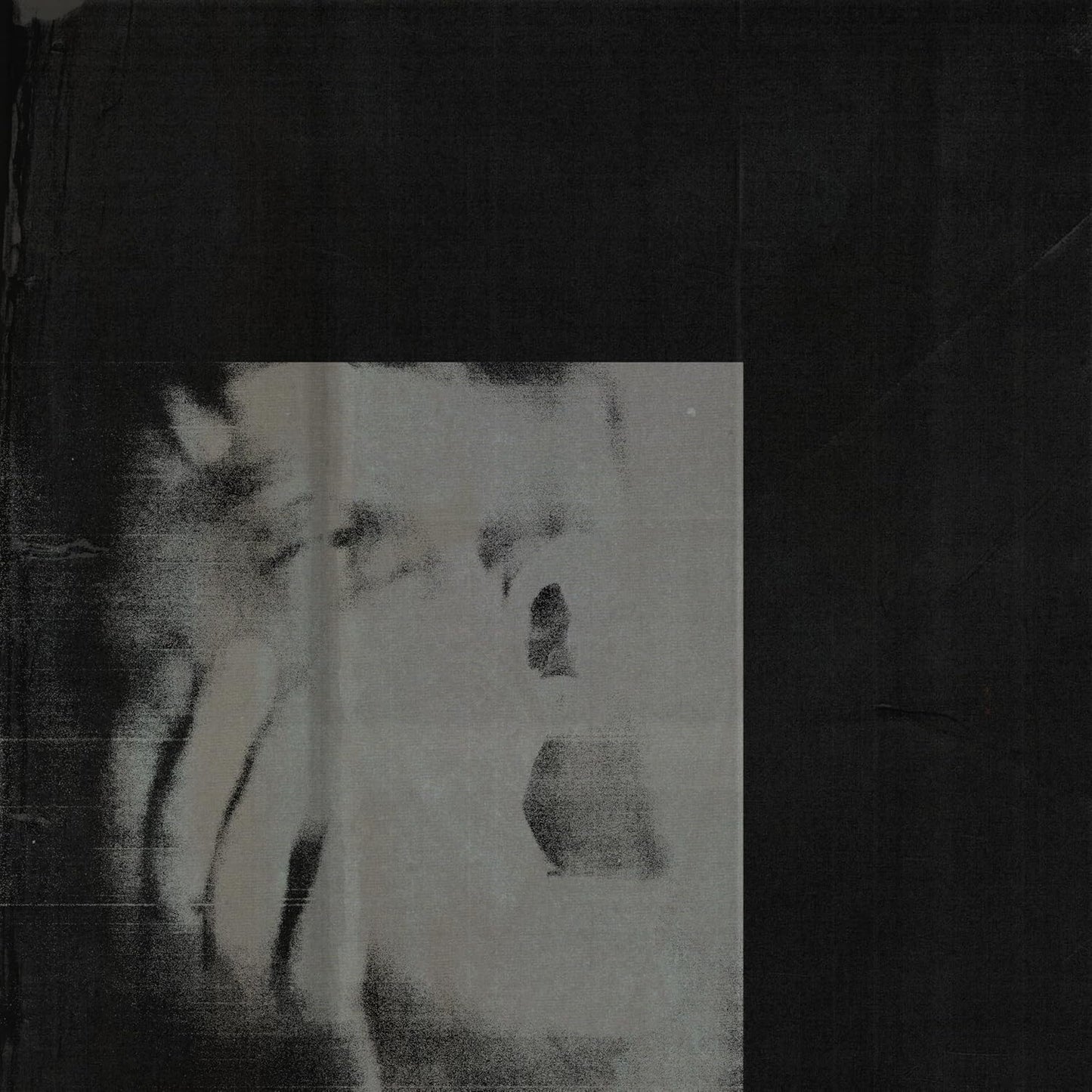 Dark, grainy CD cover with a distorted, pale face in the center.