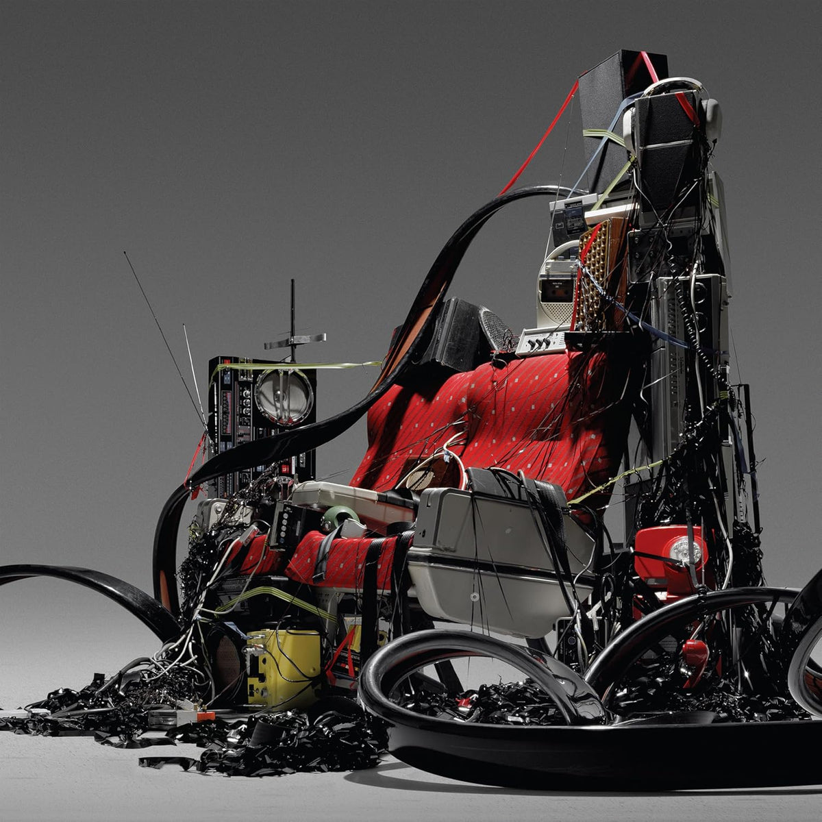 Abstract sculpture resembling a crashed vehicle with electronic components.