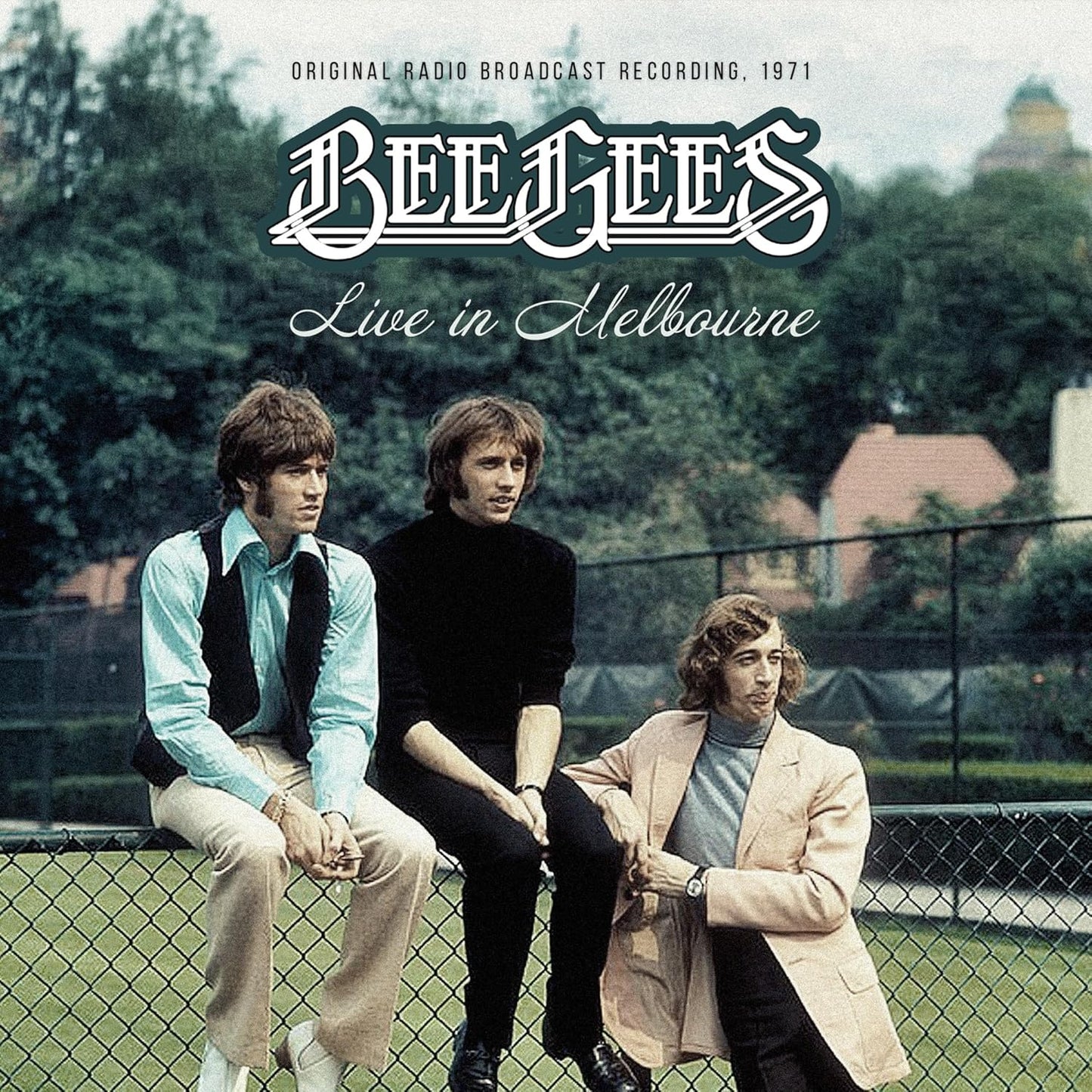 Bee Gees album cover, three men seated before a chain-link fence.