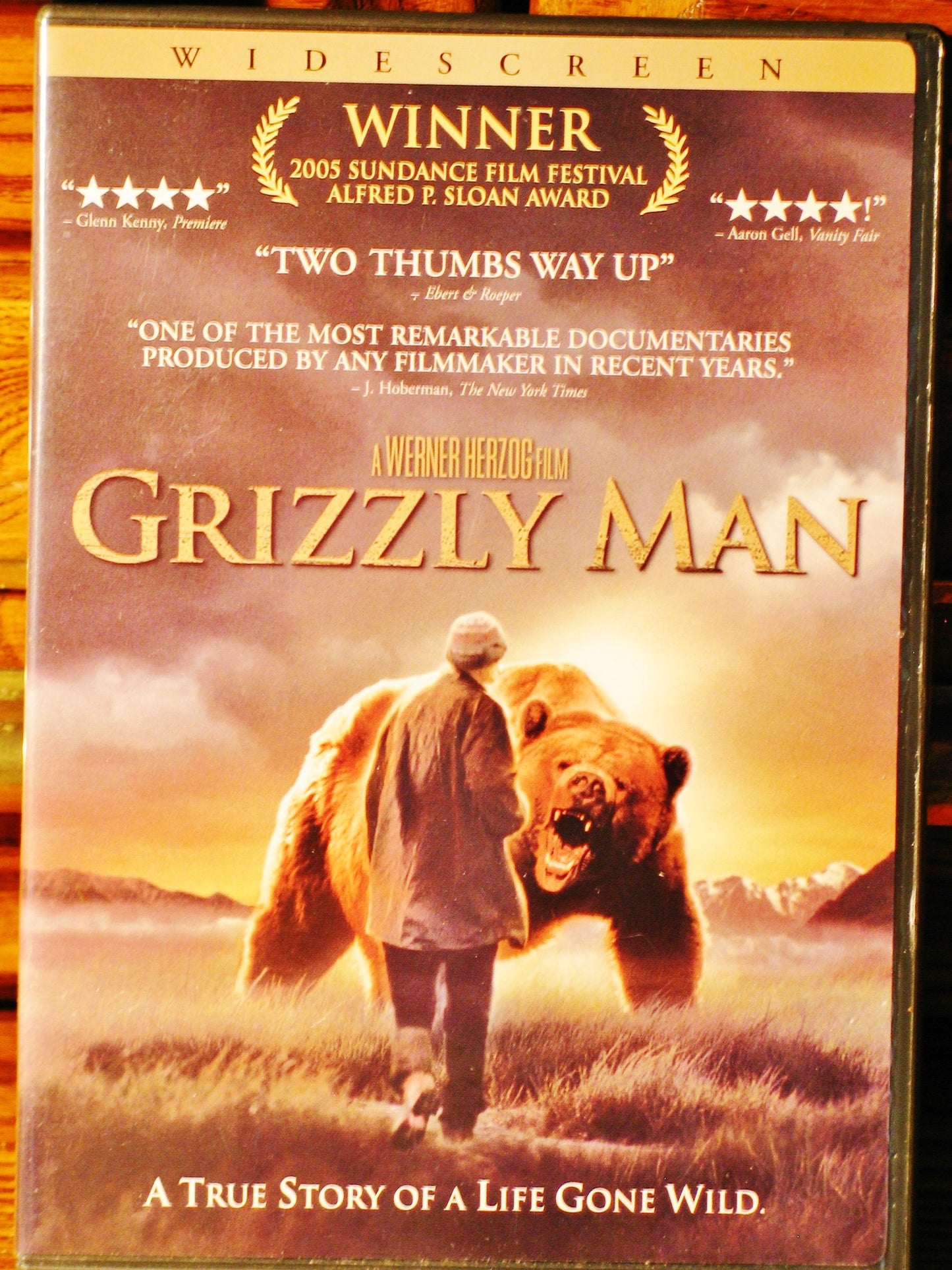 DVD cover for “Grizzly Man” featuring a brown bear in a field.