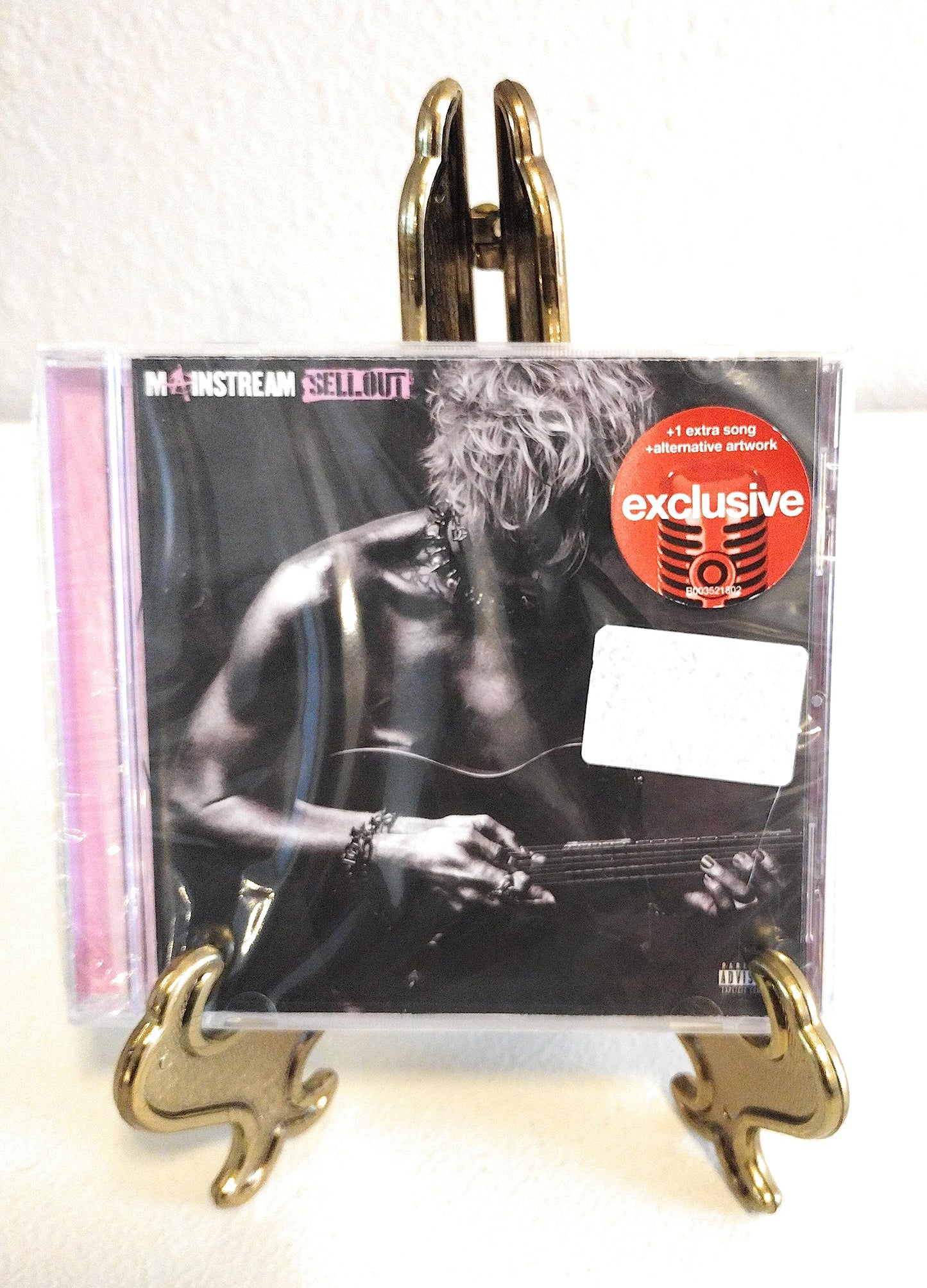 Machine Gun Kelly's "Mainstream Sellout" CD in a jewel case on a stand.