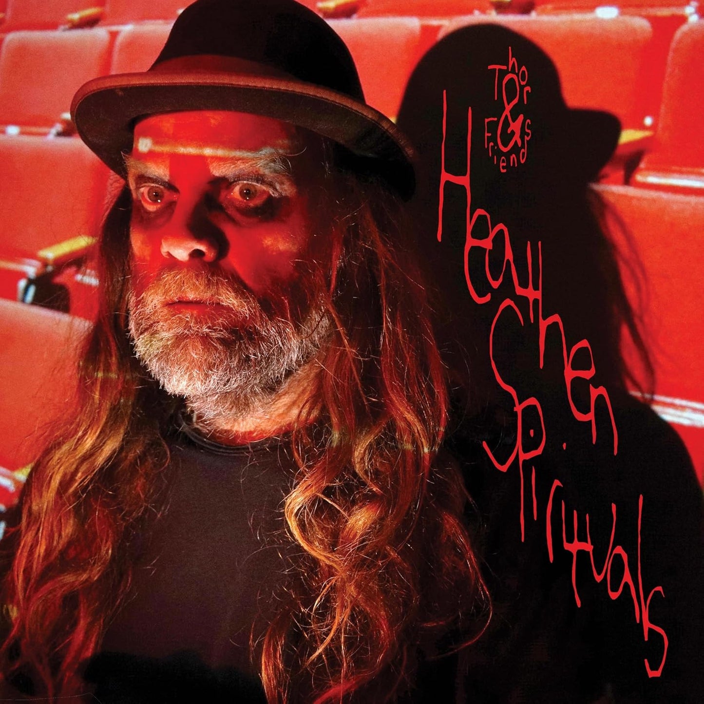 Album cover featuring a man with long hair and beard, red background.
