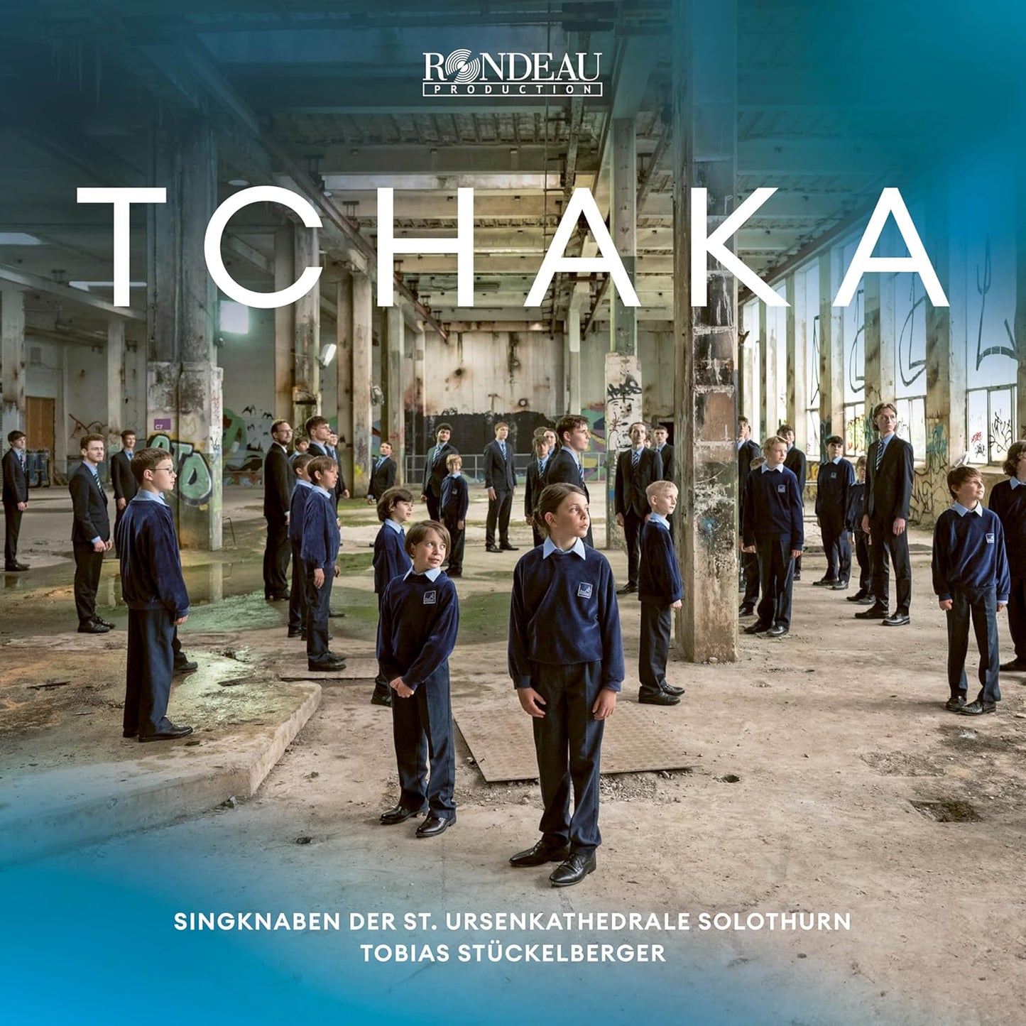 CD cover: group of boys in school uniforms standing in a large hall.