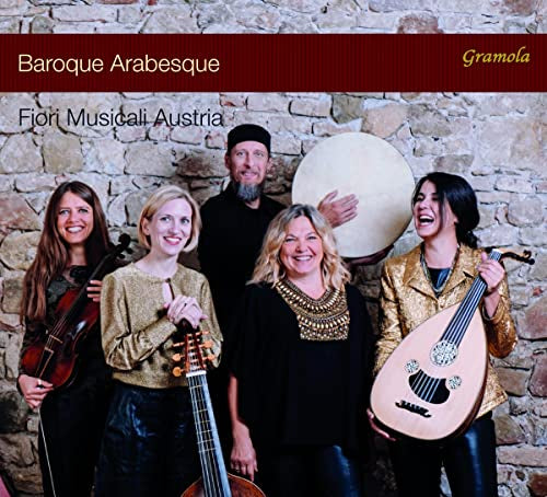 Five musicians with baroque instruments pose against a stone wall.