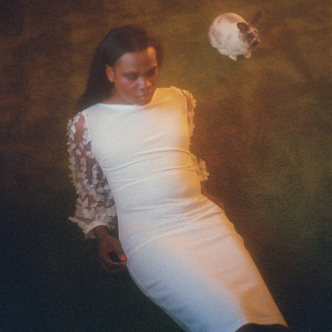 CD cover for Shamir’s “Ten” featuring a person in white against a dark background.