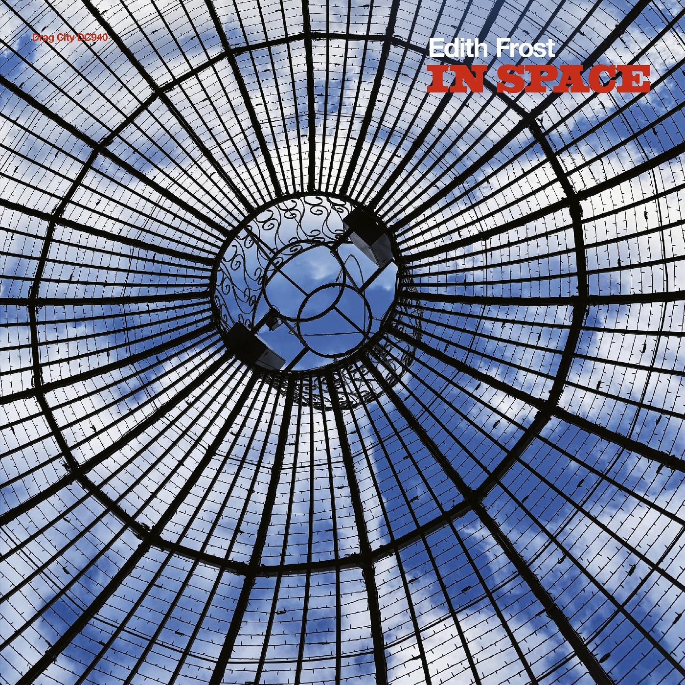Vinyl record cover: abstract radial design with blue sky and text.