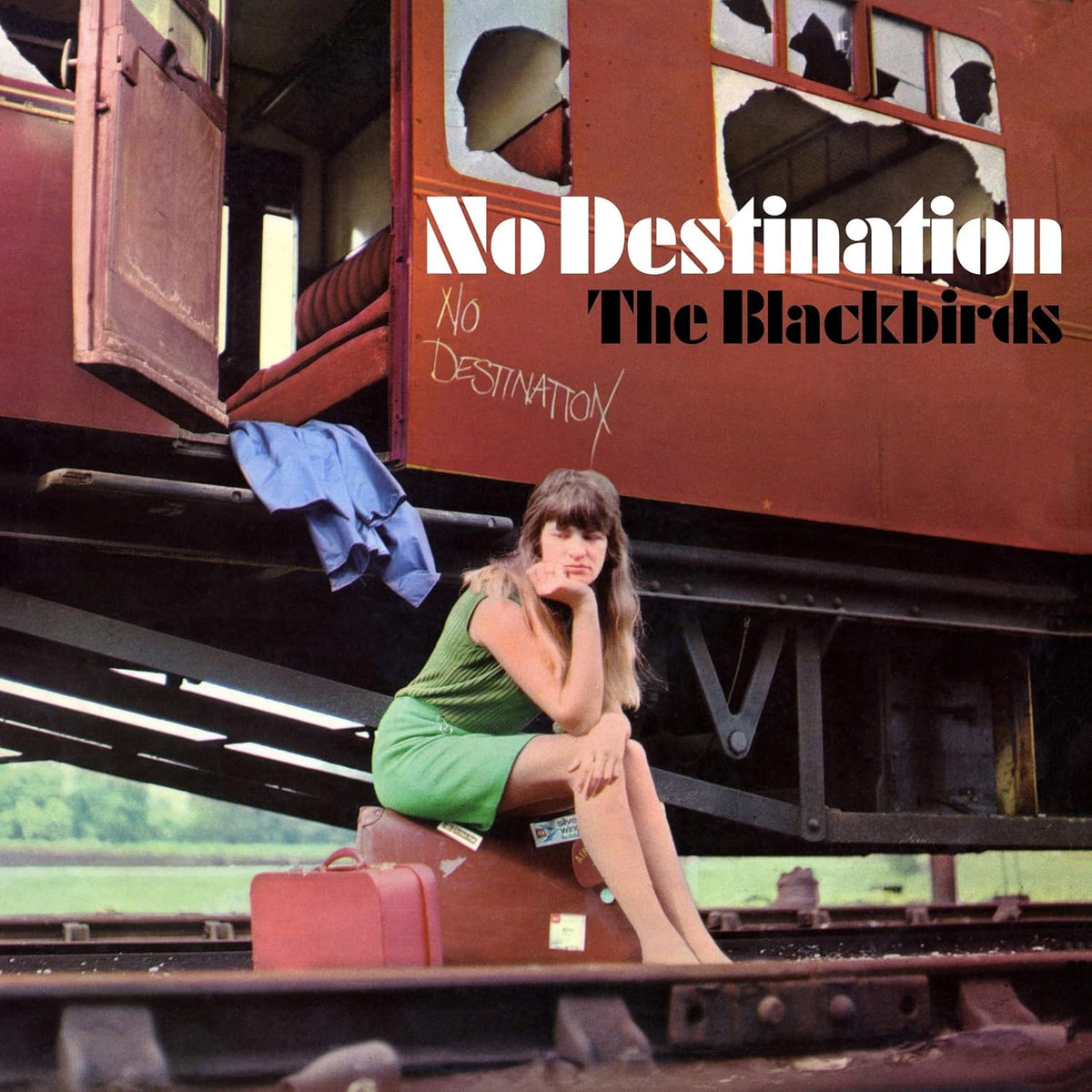 Album cover: woman with suitcase sitting on train car, "No Destination.