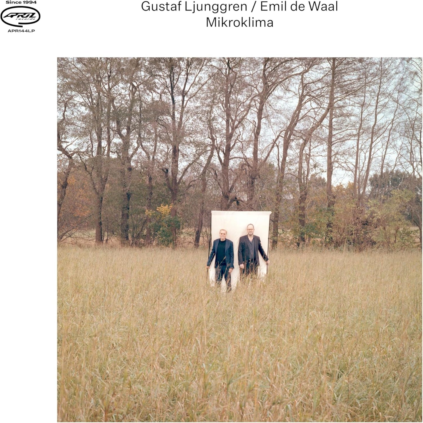 CD cover: two figures standing in a field with bare trees.
