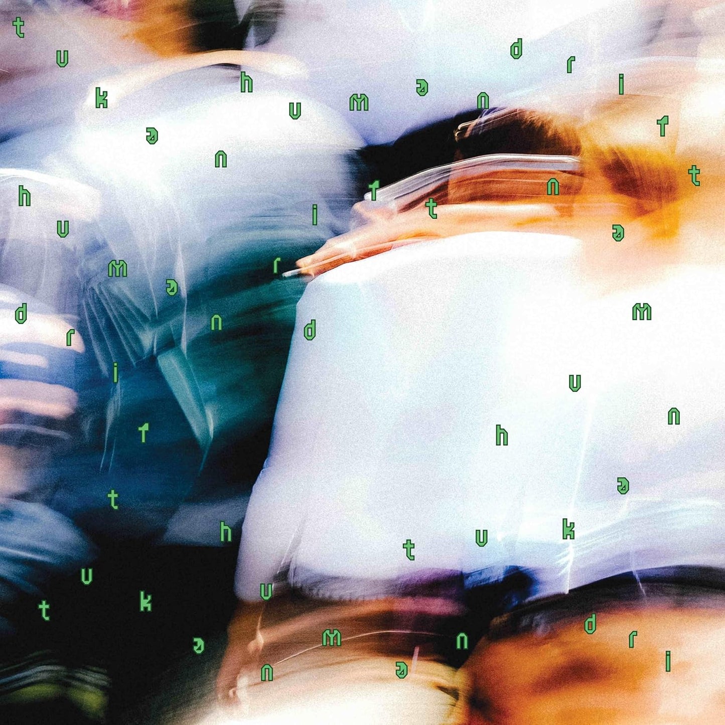 Abstract album cover with blurred faces and scattered letterforms.