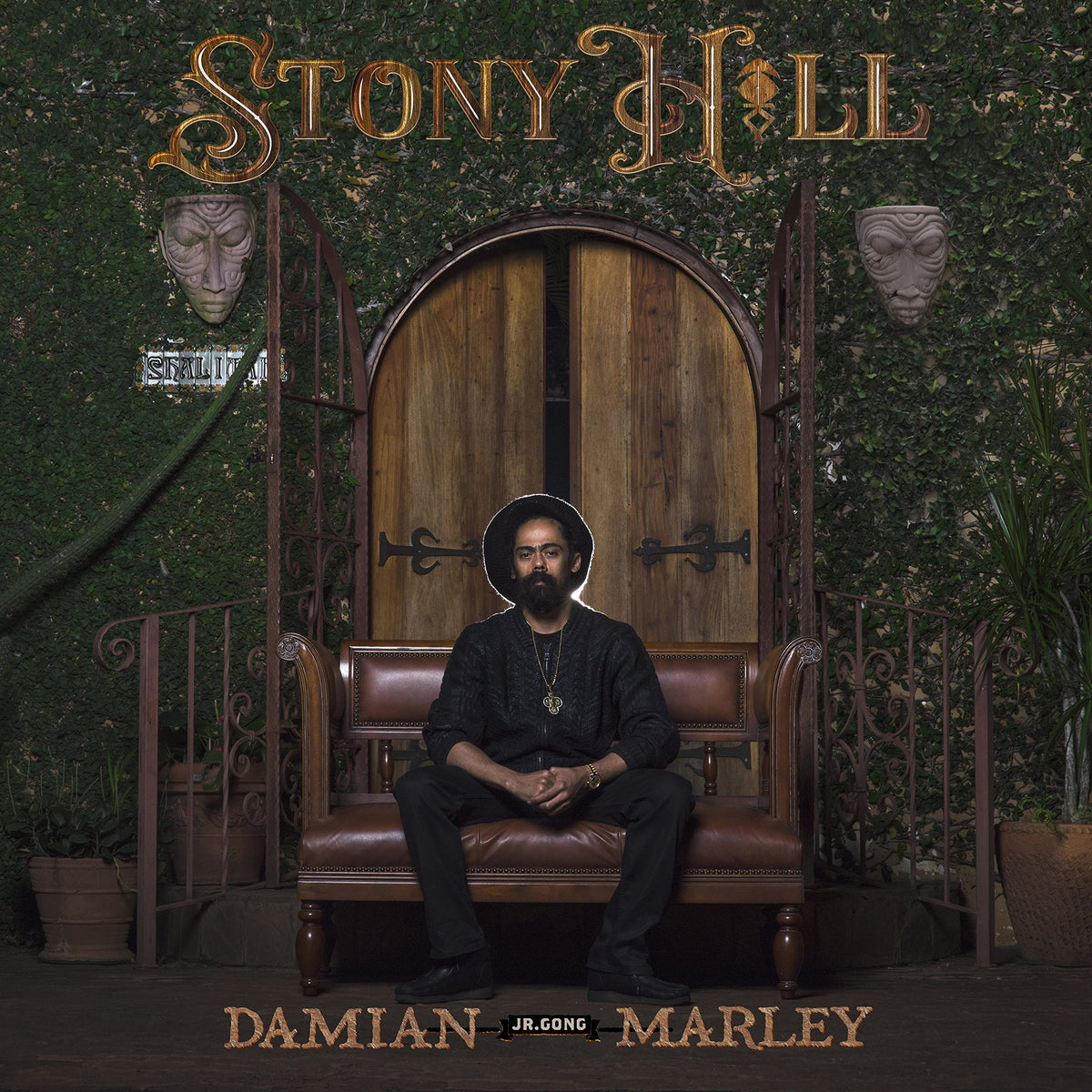 Damian Marley album cover, "Stony Hill", featuring a man seated before a doorway.