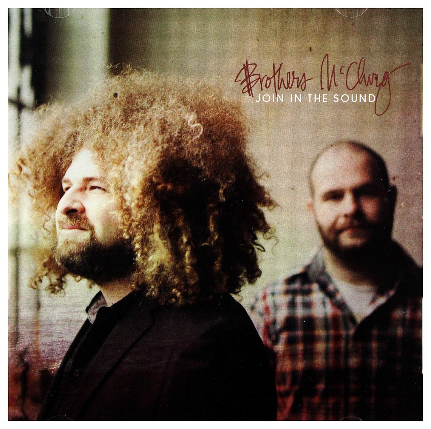 CD cover featuring two men, one with large curly hair, in sepia tones.