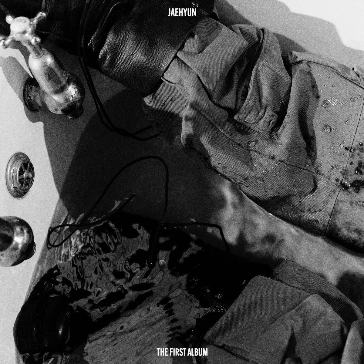 Jaehyun album cover: a person in a tub with flowing water.