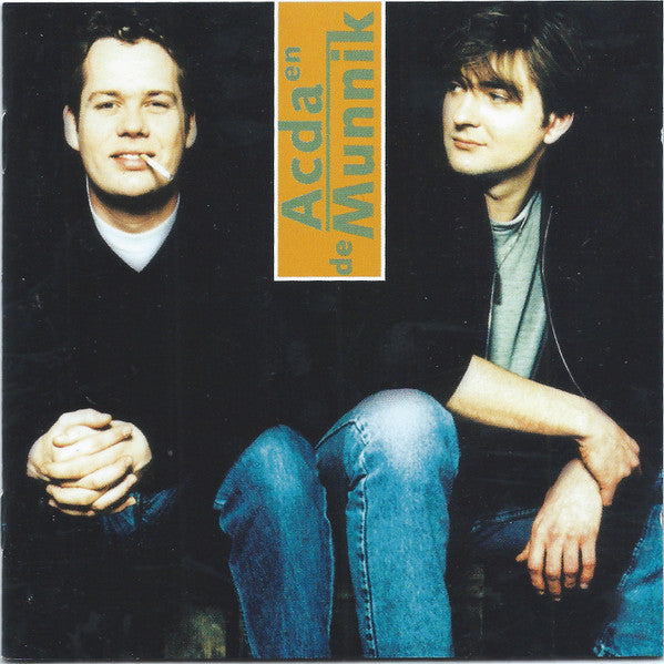 Two men in casual clothes sitting, with text on orange rectangle behind them.