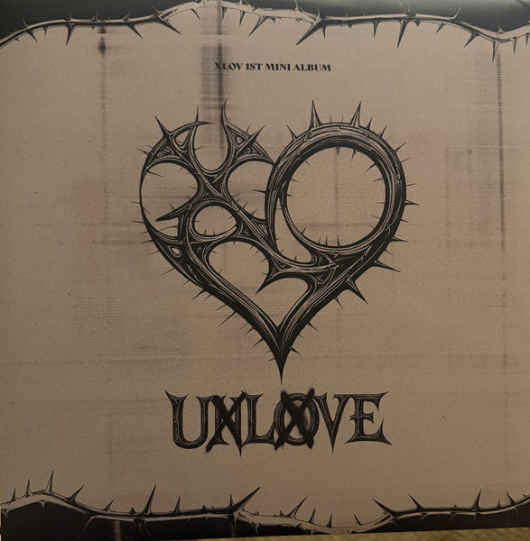 Vinyl record cover with a dark, ornate heart and the title "UXLOVE".