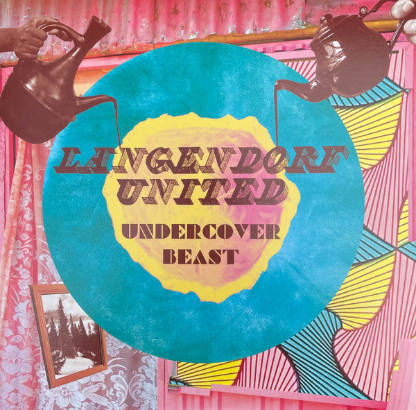 Vinyl record cover: blue circle with red text, patterned background.
