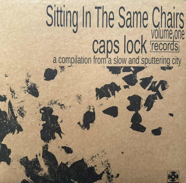 Vinyl record cover for “Sitting In The Same Chairs” compilation, abstract design.