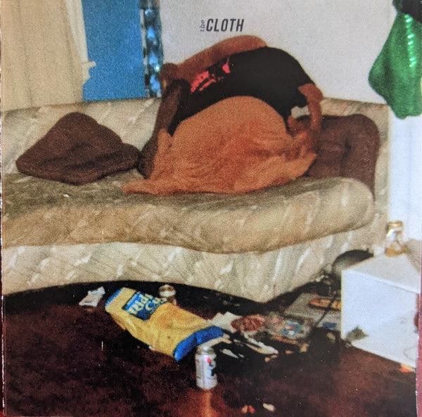 CD cover for "The Cloth - Touched" showing a person lying on a bed.