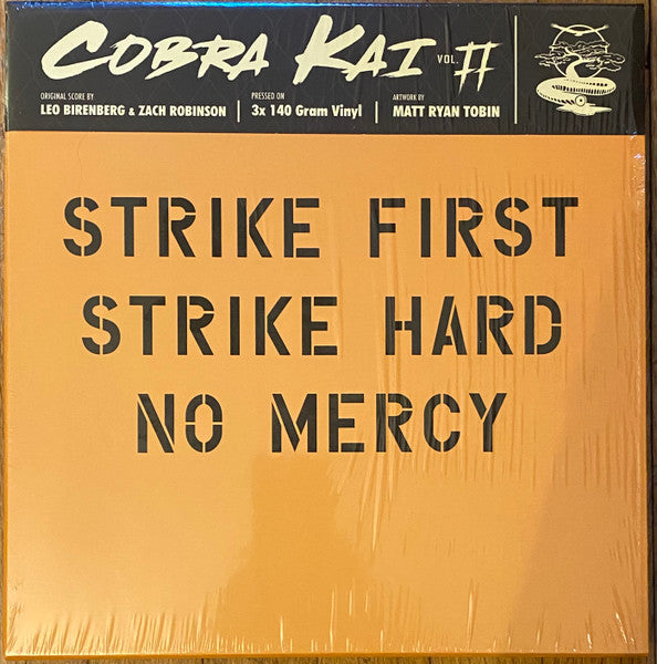 Vinyl record cover with orange background and black stencil text reading "STRIKE FIRST STRIKE HARD".