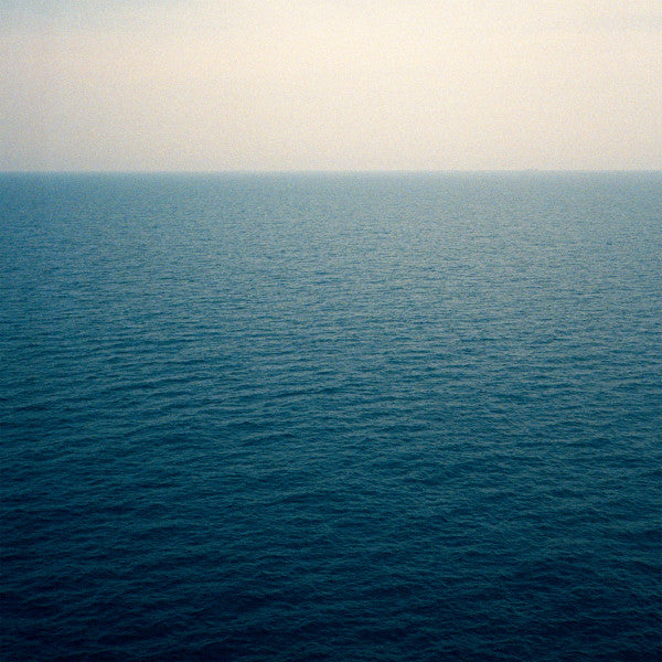 Calm, expansive ocean view with a gradient from dark to light blue.