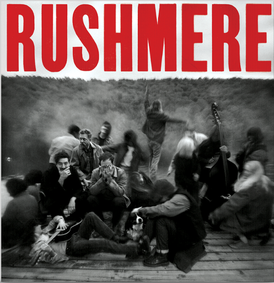 “Mumford & Sons - RUSHMERE” CD cover with blurred group photo.