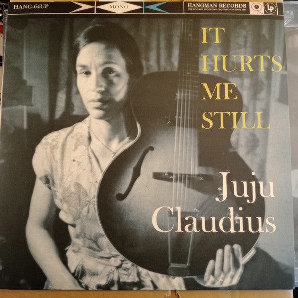 Black and white vinyl record cover featuring a portrait of Juju Claudius with a guitar.