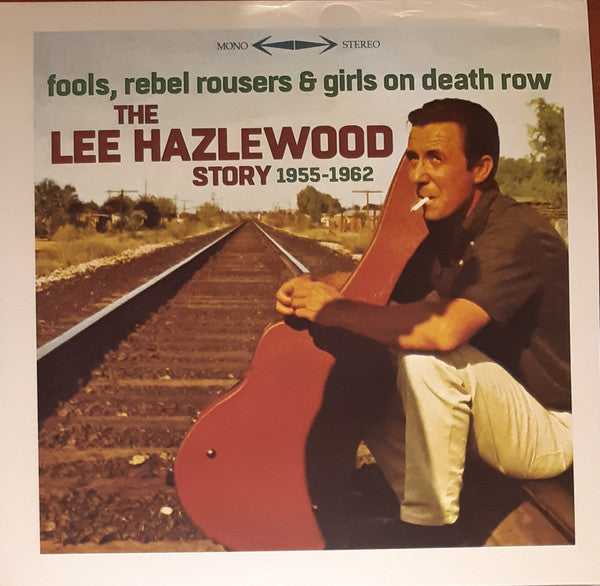Album cover featuring a man with a guitar sitting by railroad tracks.