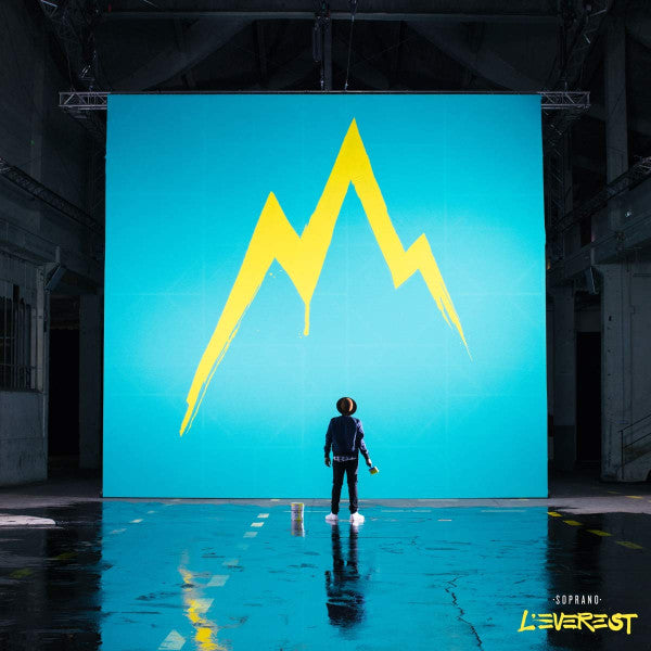 Album cover: person facing yellow mountains on a blue background.