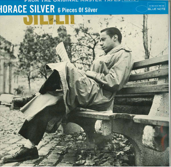 CD cover: Horace Silver reading on a park bench, black and white.