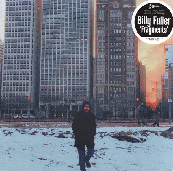 Vinyl record cover: man in snow, city buildings in background.