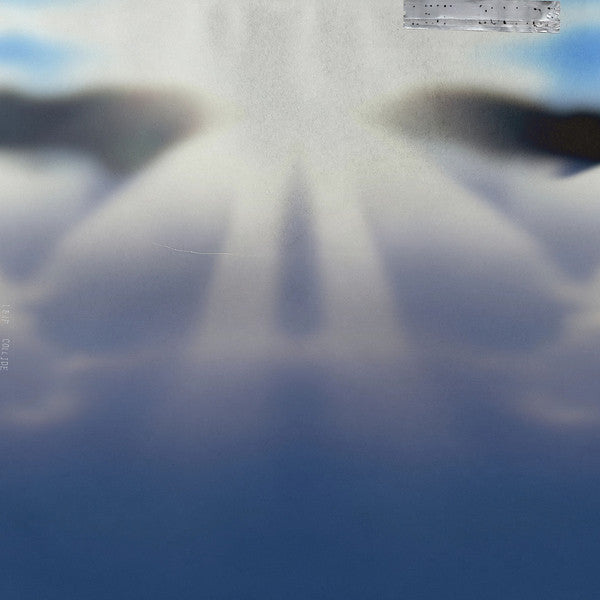 Blurred abstract album cover with pale blues and a small sticker.