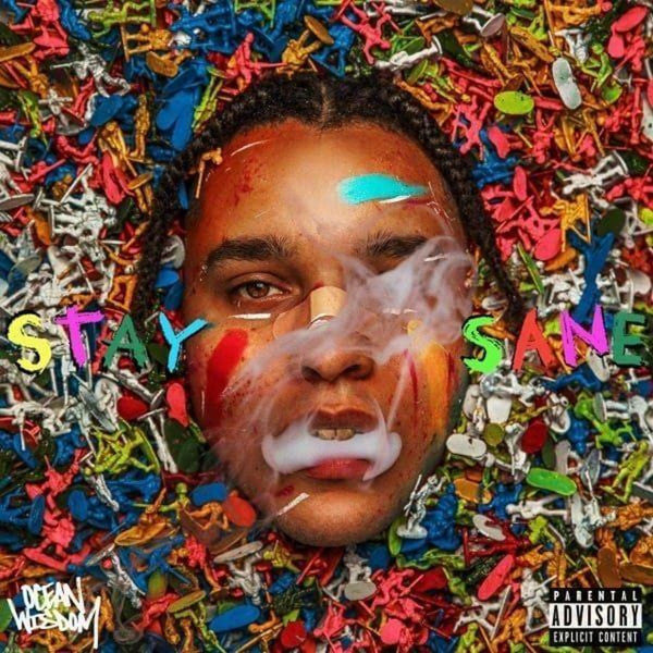 CD cover with a man’s face surrounded by colorful plastic figures.