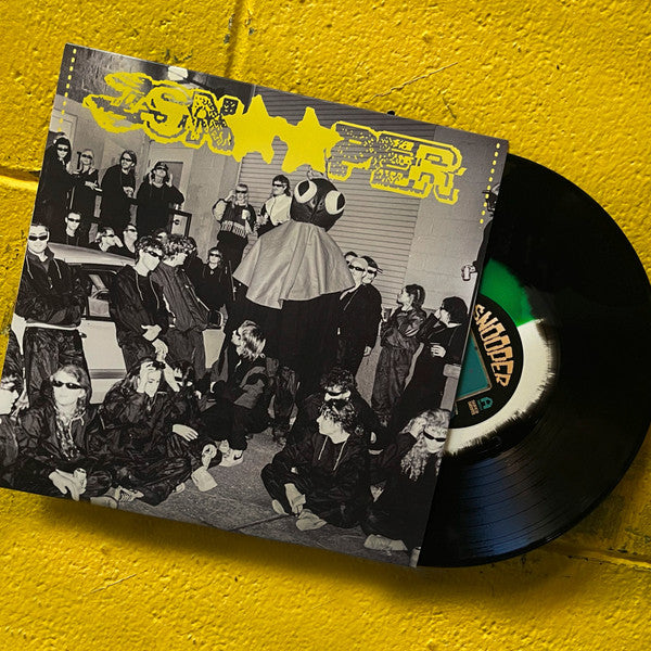 Vinyl record with black cover featuring a group in sunglasses.