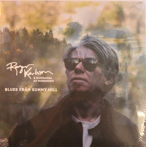 Vinyl album cover featuring a portrait of a man in sunglasses.