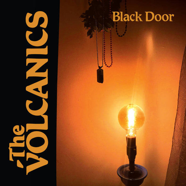 Album cover with a glowing light bulb and beads against an orange wall.