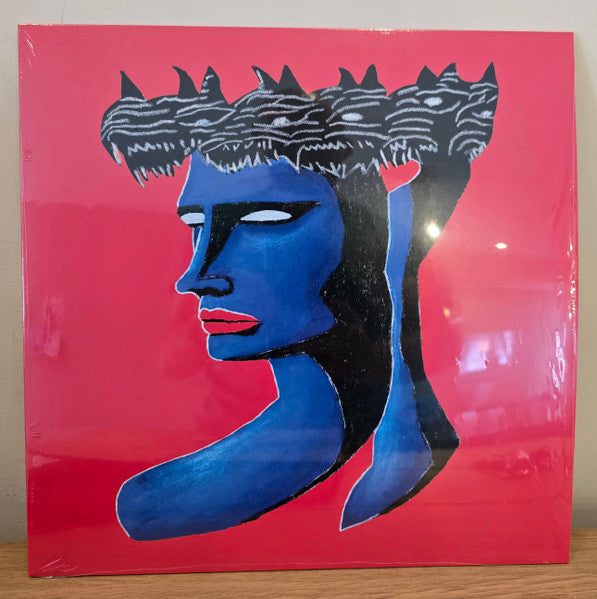 Vinyl record cover with a blue and black illustrated face on red.