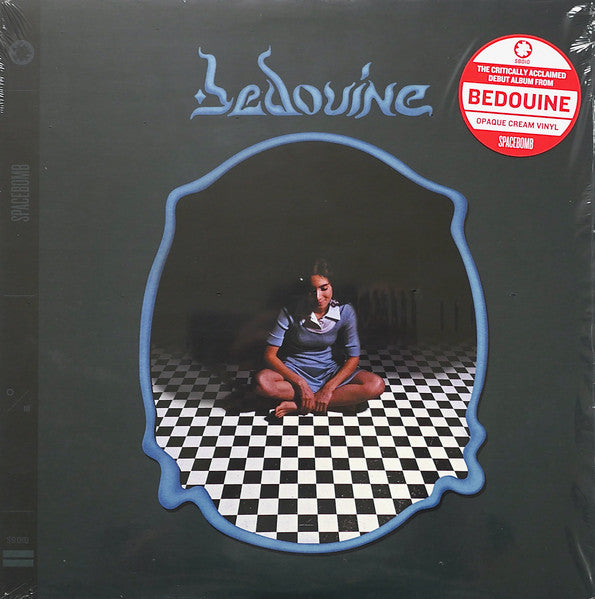 Vinyl record album cover featuring a woman seated on a checkered floor.
