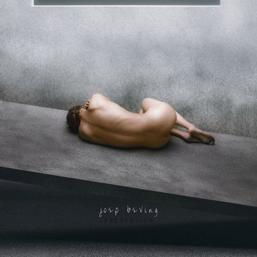 Album cover: nude person curled on a gray concrete surface.