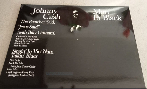 Johnny Cash “Man In Black” vinyl record album cover, dark background.