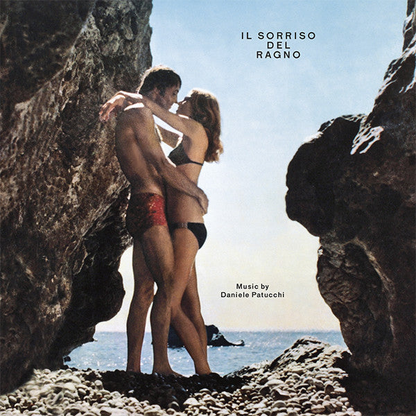 Couple embracing on a rocky beach, CD cover art.