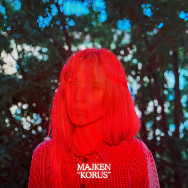 Red-haired person in a forest, album cover for “Korus” vinyl.