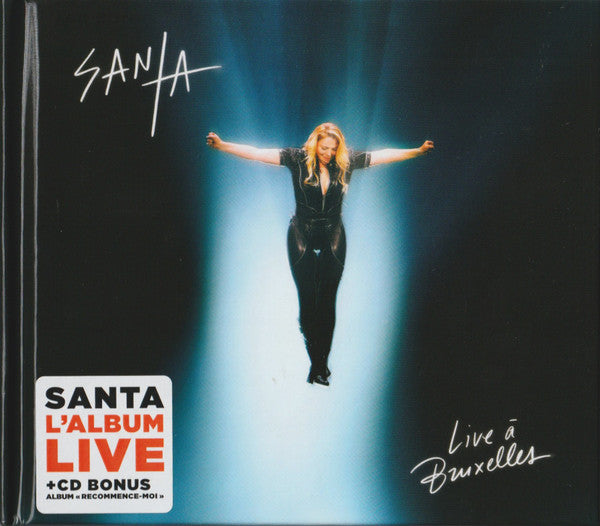 CD cover featuring Santa, arms outstretched, in a spotlight.