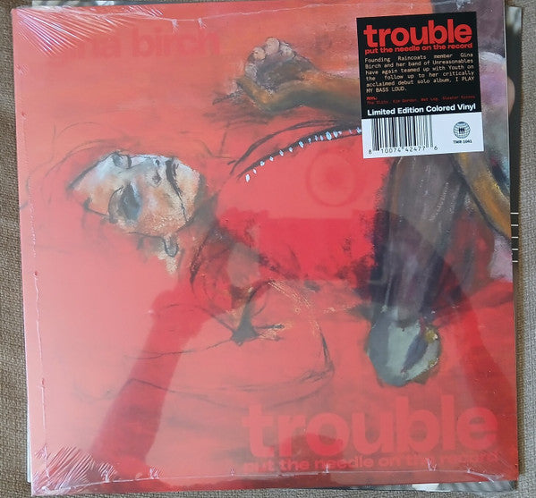 Sealed vinyl record of Gina Birch’s “Trouble” with red and black abstract cover art.